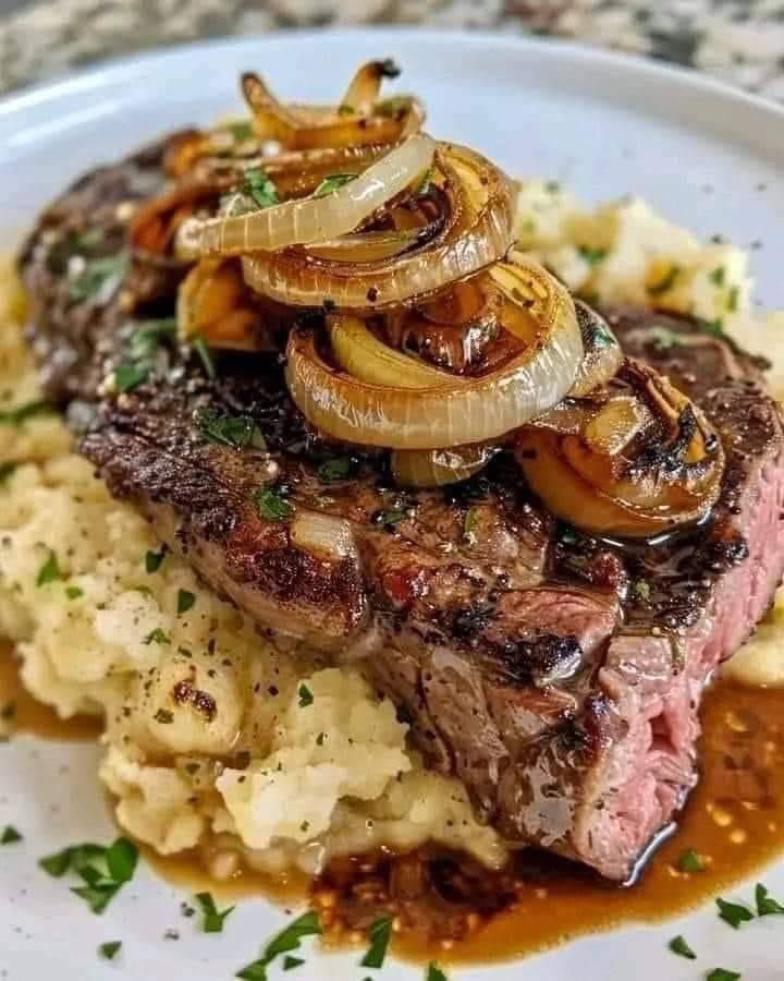 RIBEYE STEAK WITH CARAMELIZED ONIONS AND MASHED POTATOES